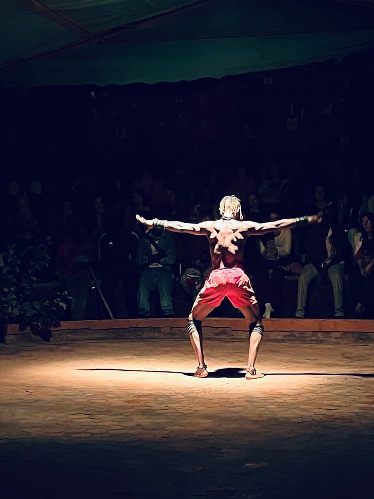 Solo dancer mid-performance under stage light